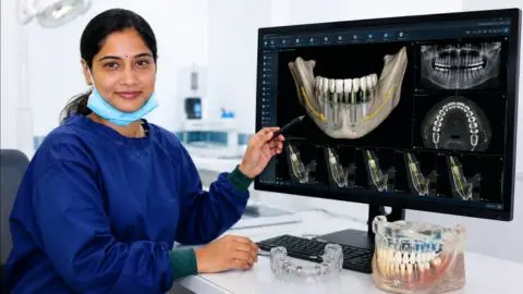 Dr Bhavya Edara reviewing CBCT scans and digital implant planning software for Computer Guided Implant Surgery in Vijayawada